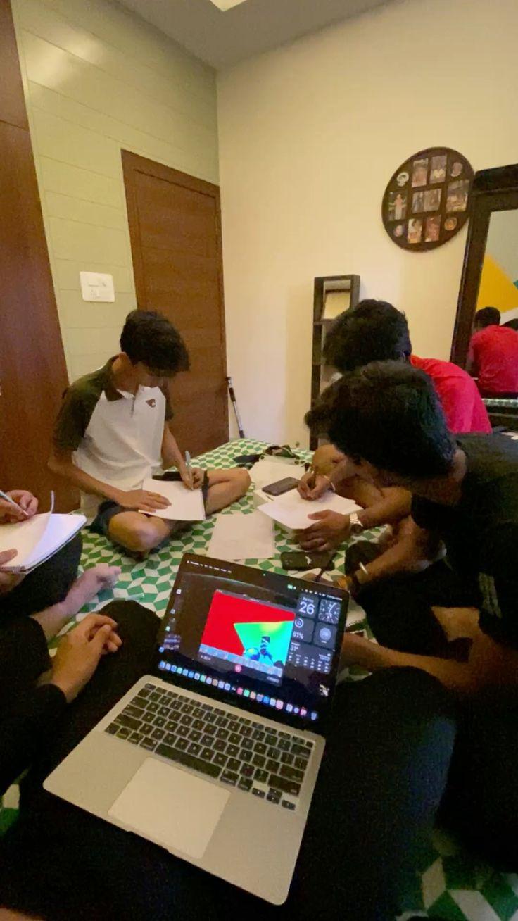 Students sitting around a low table working through notes together